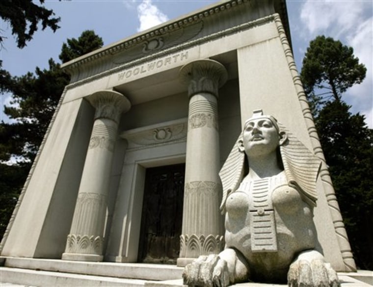 In this Tuesday, July 20, 2004 file photo, a stone sphinx is shown at the entrance to the Woolworth mausoleum at Woodlawn Cemetery in the Bronx, New York. Burial in a Woodlawn mausoleum can cost more than $1 million.